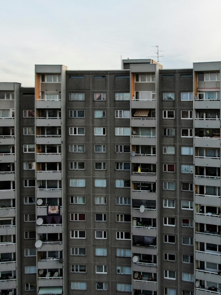 Ein über zehnstöckiger grauer Plattenbau mit Balkonen